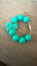 Turquoise bow cup charm