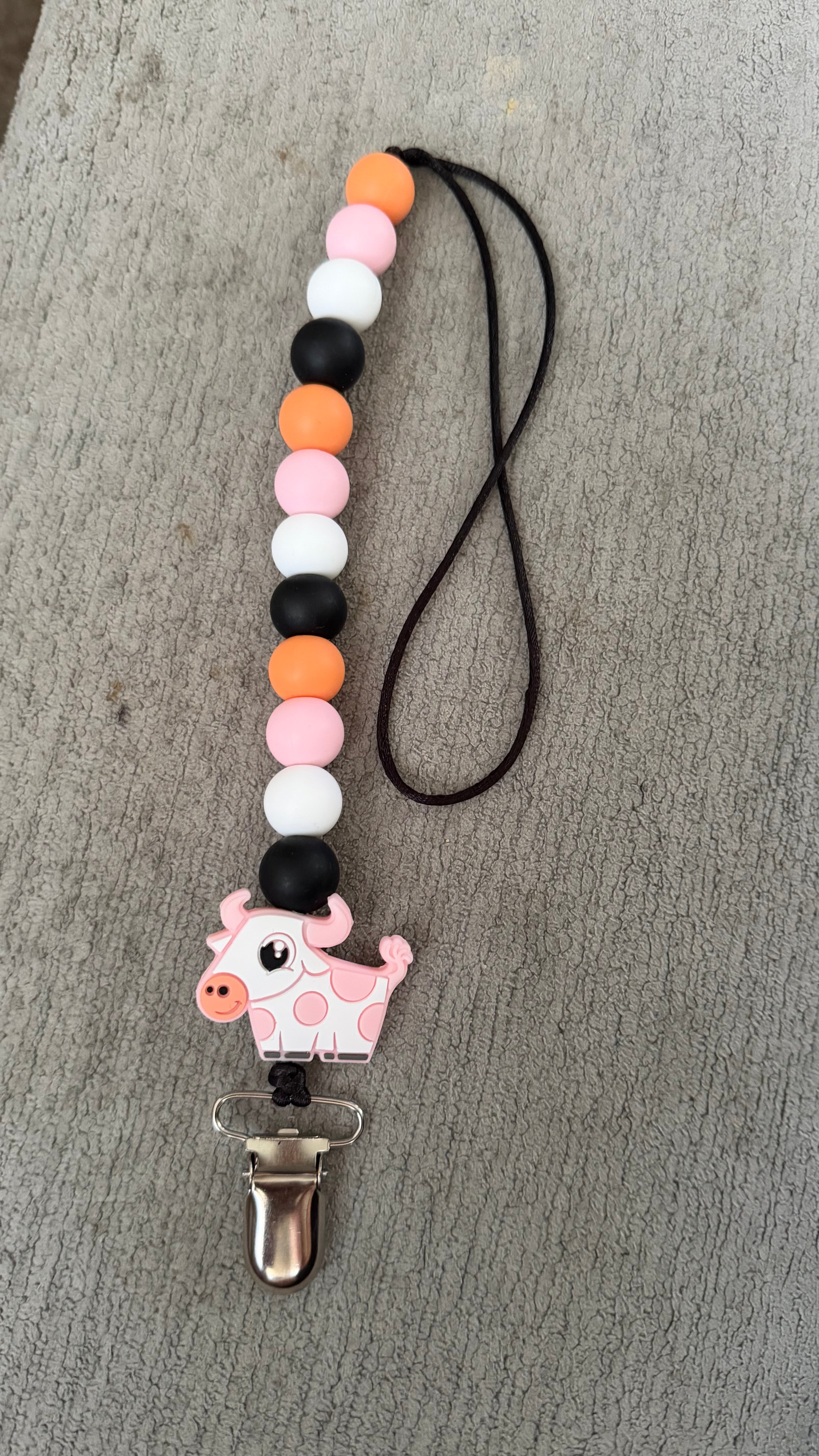 Pink cow pacifier clip