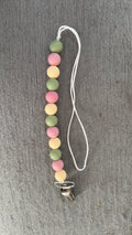 Pink and green pacifier clip