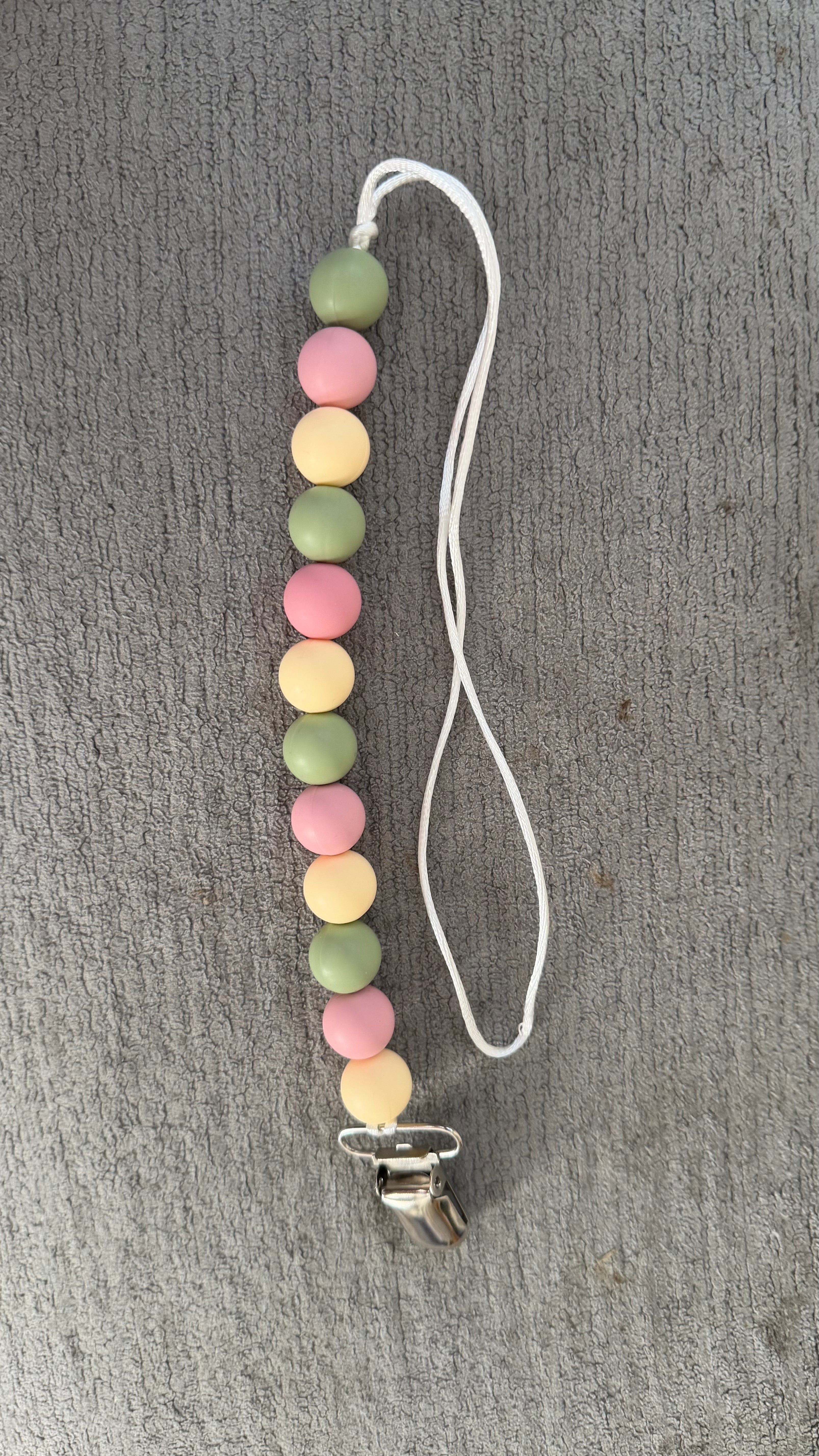 Pink and green pacifier clip