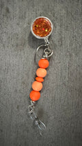 Orange jeweled beaded badge reel