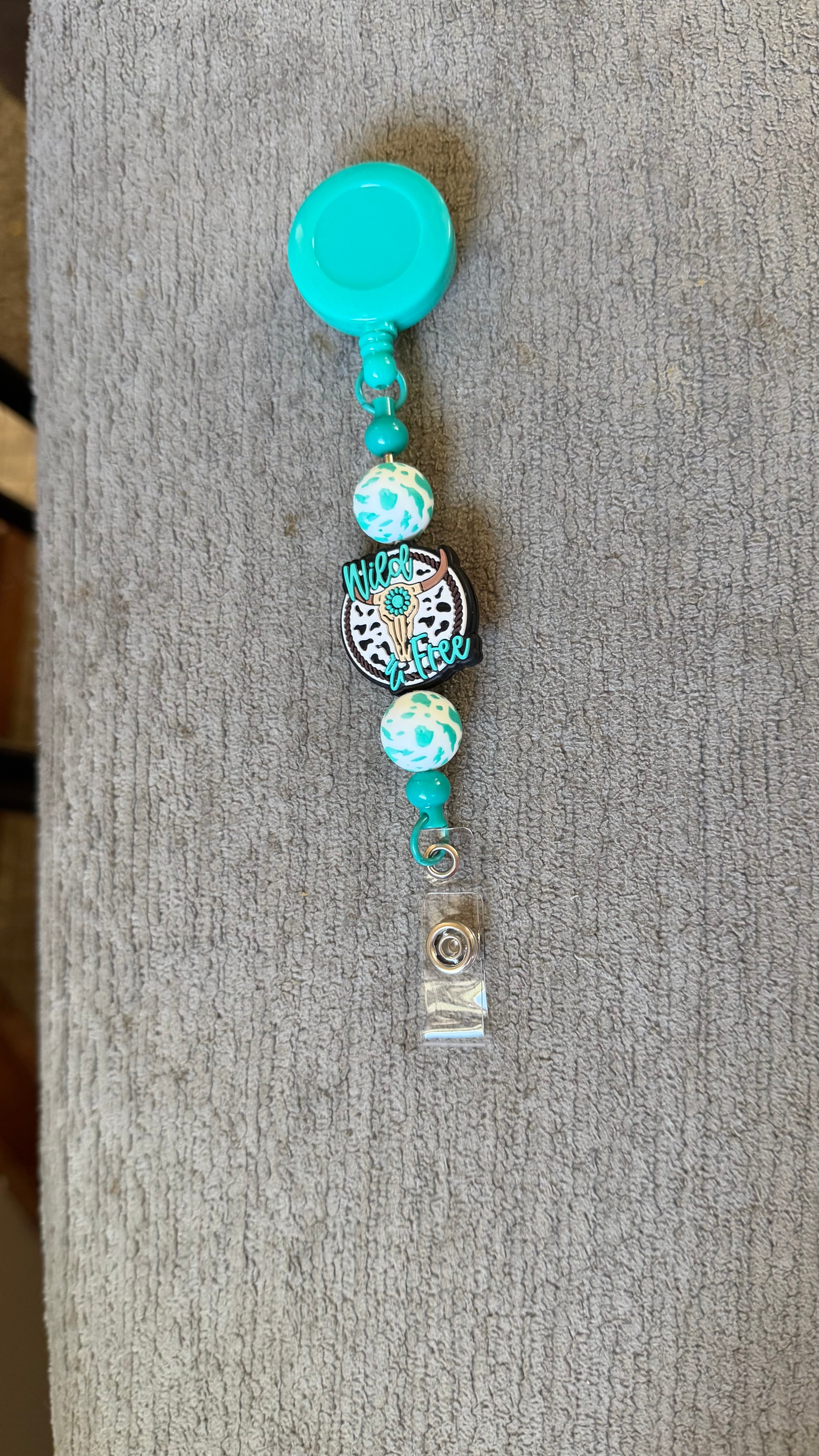teel cow beaded badge reel
